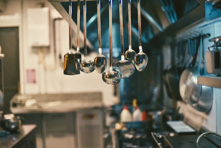 Commercial kitchen with cleaned stainless steel surfaces and properly maintained equipment