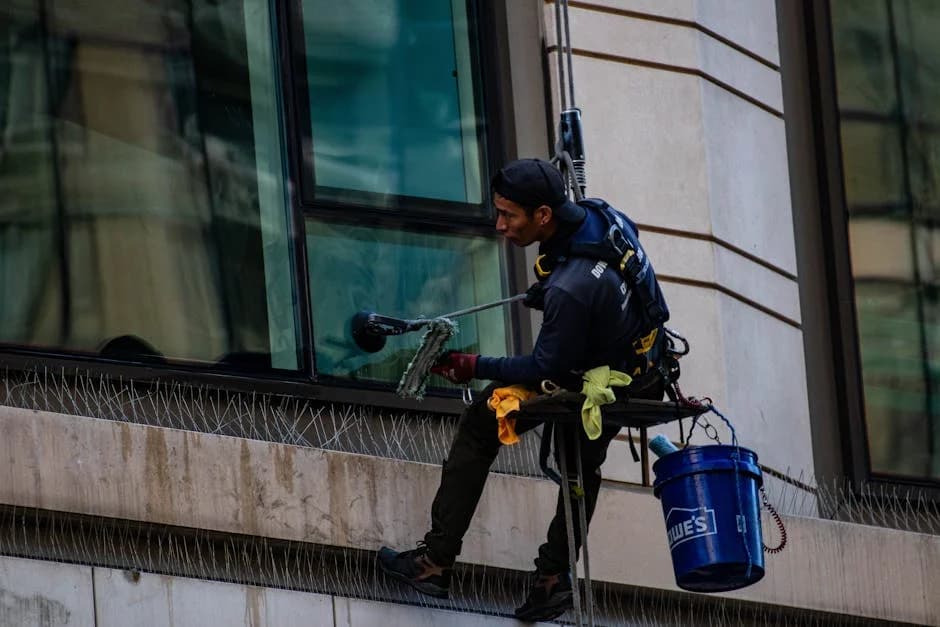 Professional window cleaning crew working on a commercial building exterior