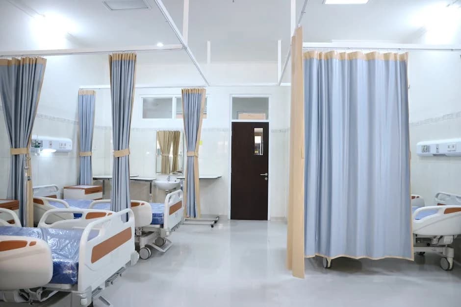 Healthcare professional disinfecting patient room surfaces with proper protective equipment