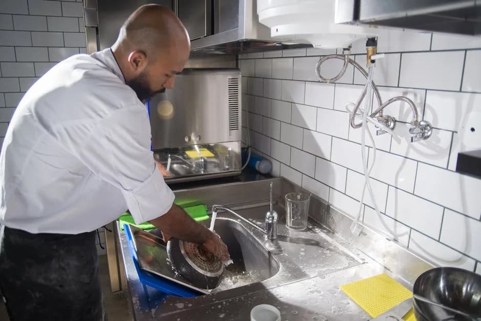 Professional restaurant cleaning crew maintaining a commercial kitchen
